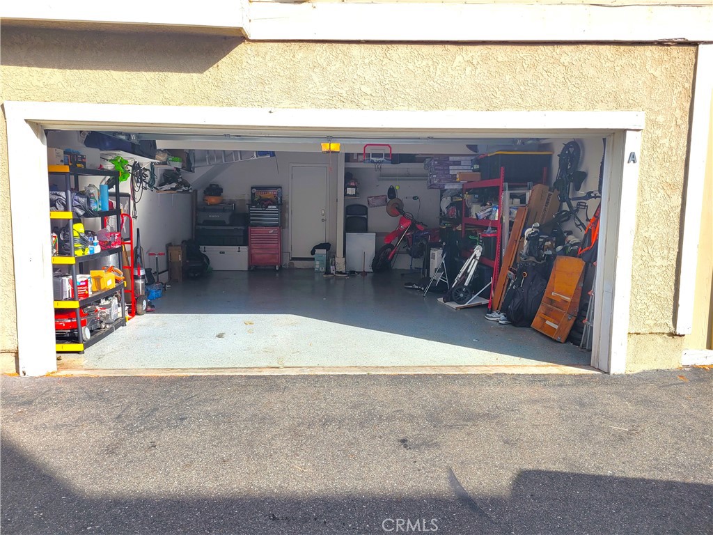 28162 Sloan Canyon Road, Unit A Castaic, CA 91384 - Photo 25 of 30 a view of a garage with rack and white refrigerator