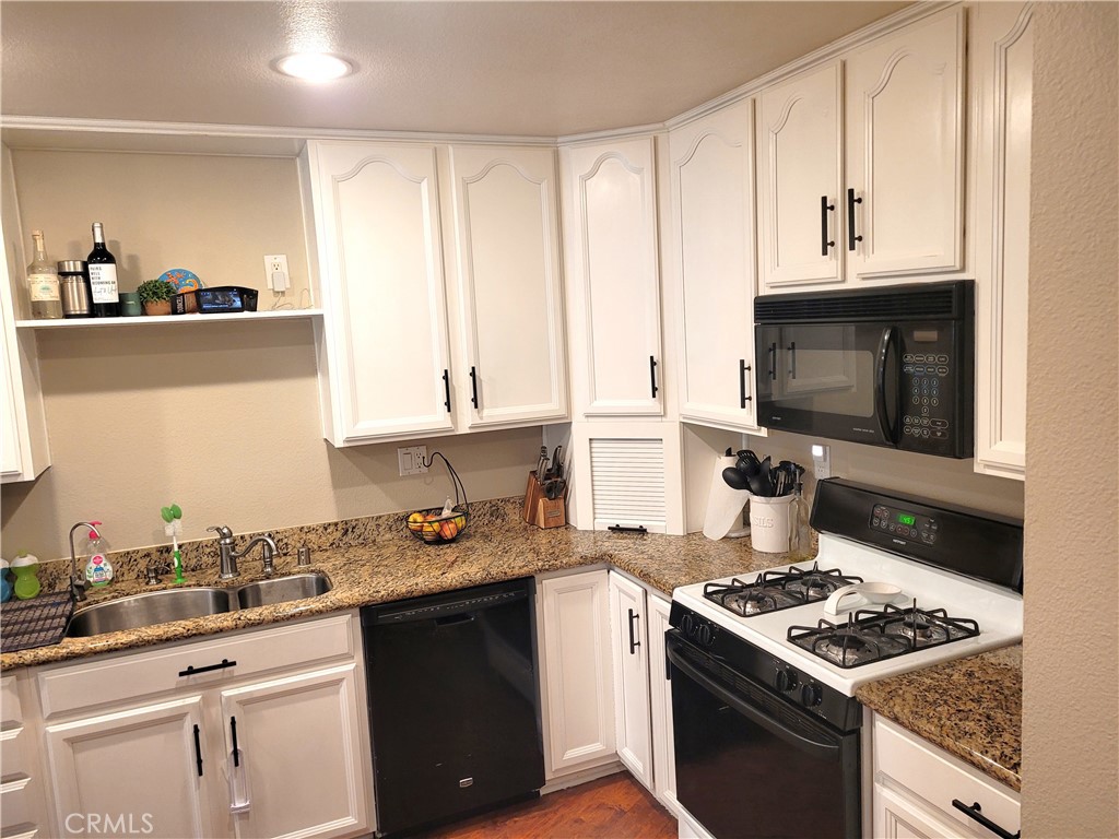 28162 Sloan Canyon Road, Unit A Castaic, CA 91384 - Photo 7 of 30 a kitchen with stainless steel appliances a stove a sink and a microwave
