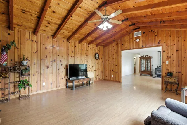 a view of a livingroom with furniture and a flat screen tv