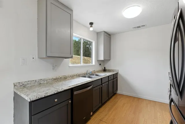 a kitchen with a sink and a window