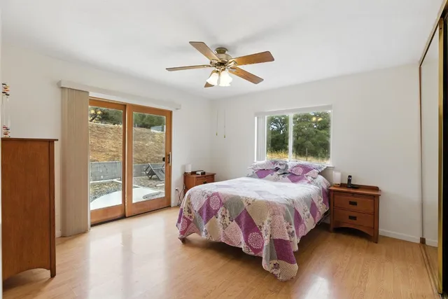 a bed sitting in a bedroom next to a window