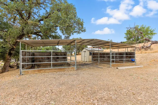 a view of a house with a yard and wooden fence
