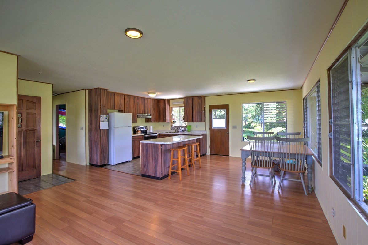60 Hoaka Road Hilo, HI 96720 - Photo 2 of 24 a kitchen with stainless steel appliances wooden floor and dining table