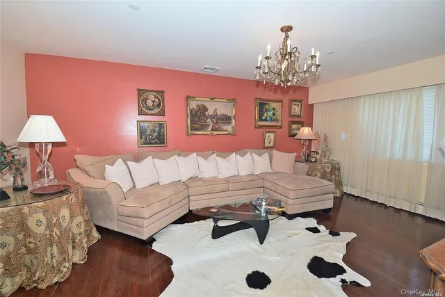 a living room with furniture and a chandelier