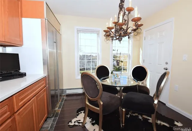 a view of a dining room with furniture and chandelier