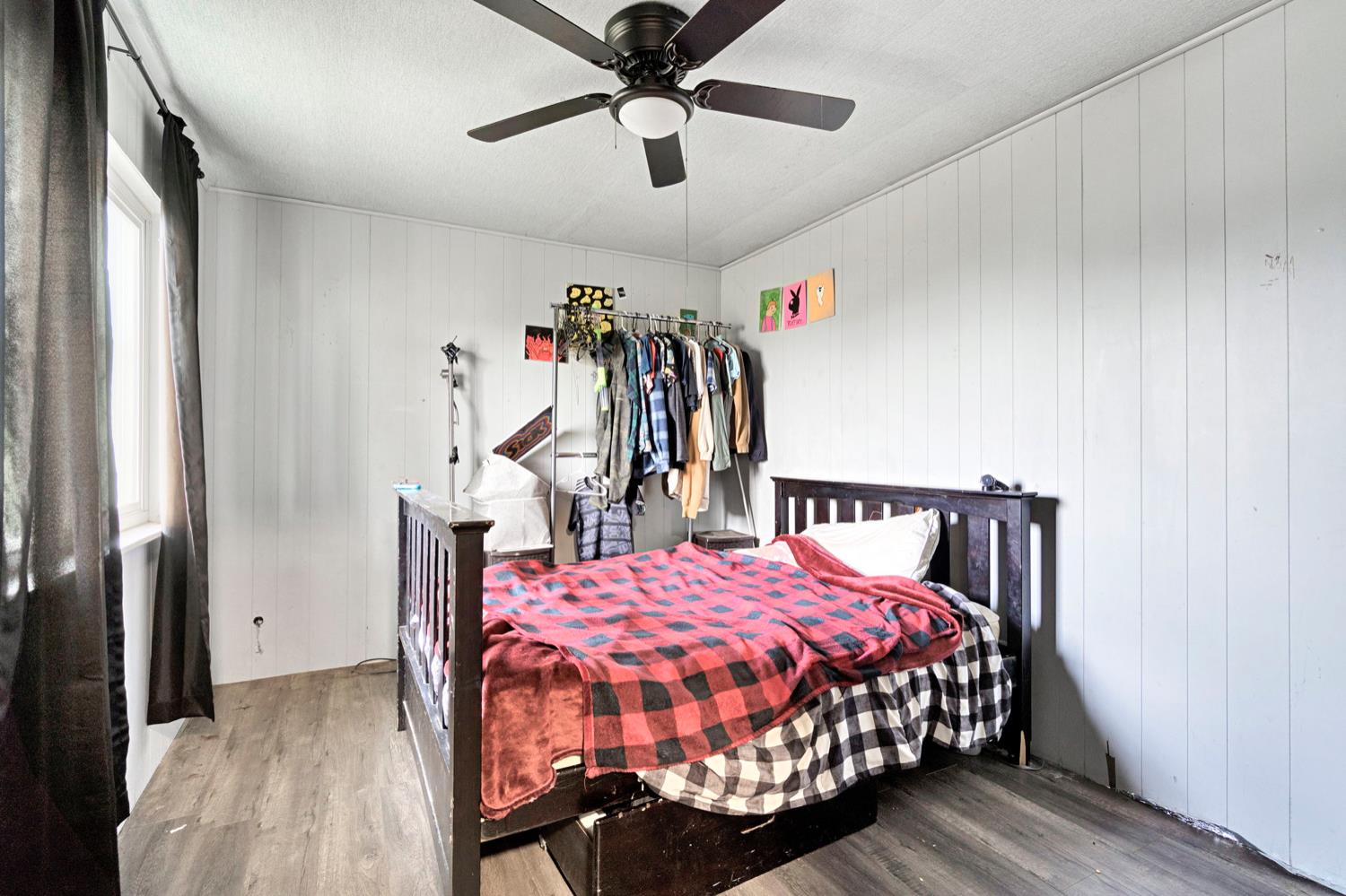 17810 Road 26 Madera, CA 93638 - Photo 11 of 39 a bedroom with a bed and a chandelier