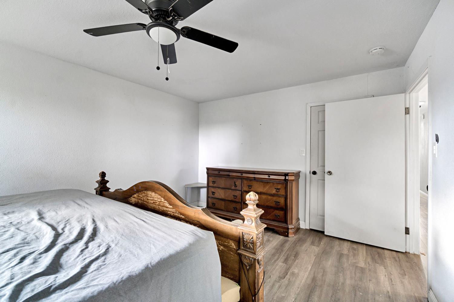 17810 Road 26 Madera, CA 93638 - Photo 14 of 39 a bedroom with a bed and wooden floor