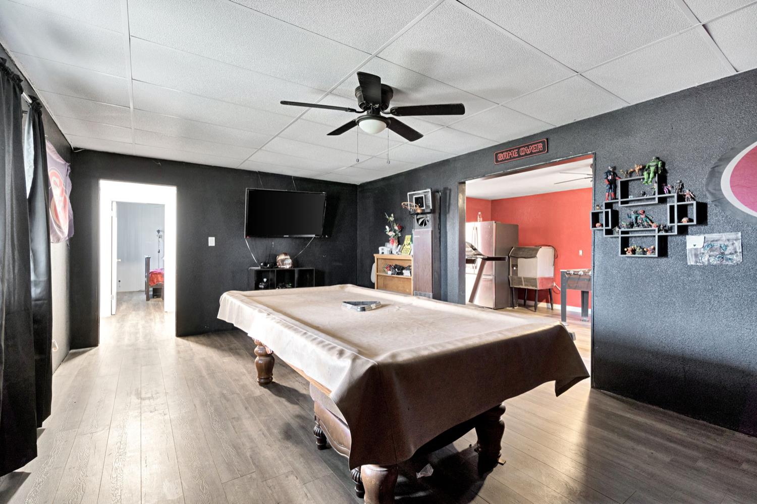 17810 Road 26 Madera, CA 93638 - Photo 5 of 39 a bed room with a bed and a chandelier