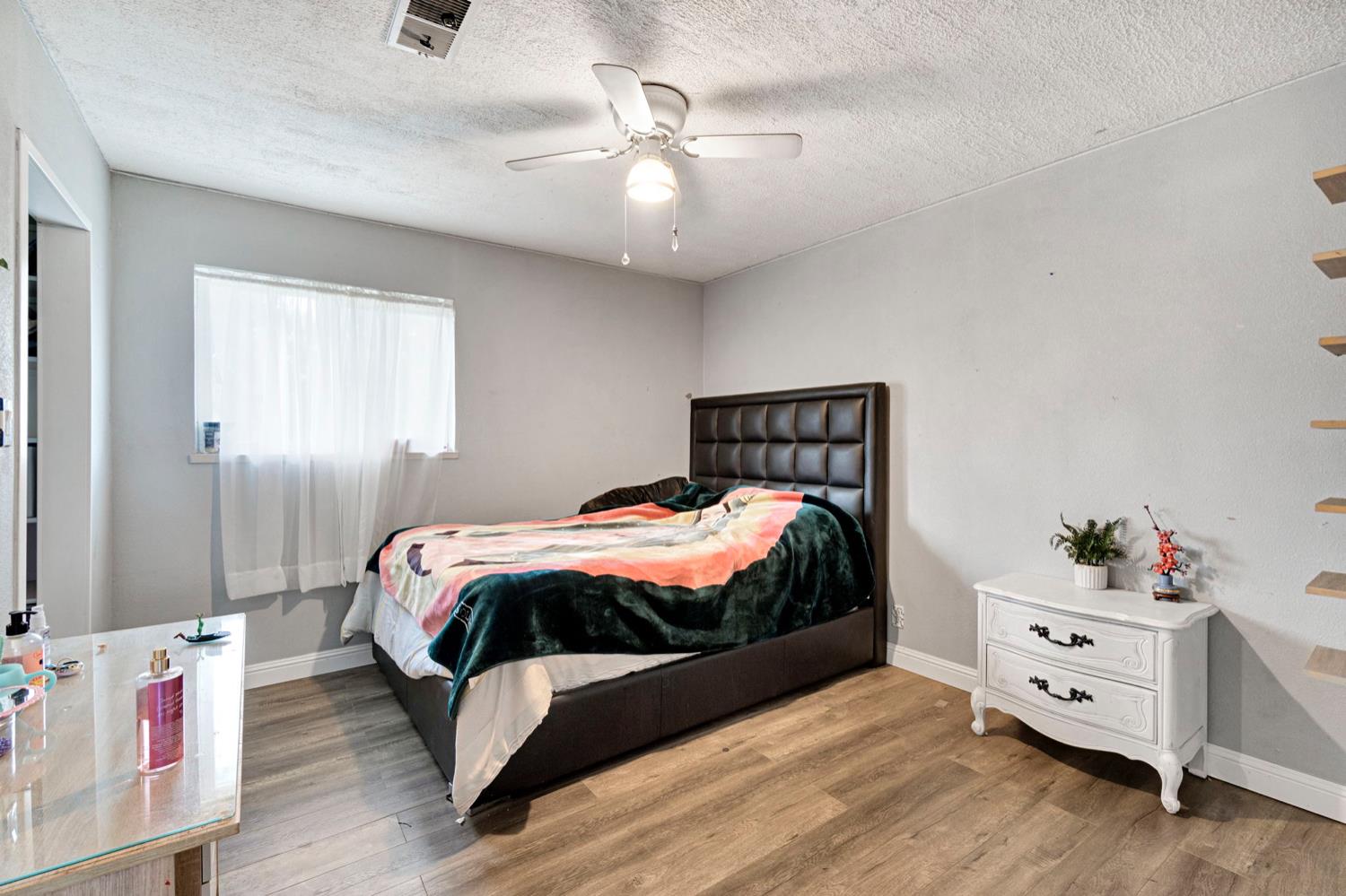 17810 Road 26 Madera, CA 93638 - Photo 8 of 39 a bedroom with a bed and a dresser