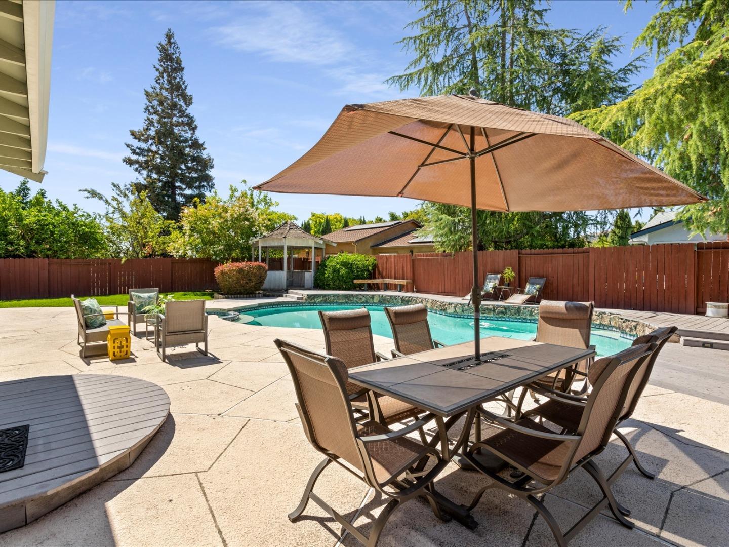 821 Pinehurst Place San Ramon, CA 94583 - Photo 22 of 26 a view of an outdoor sitting area with furniture and umbrella