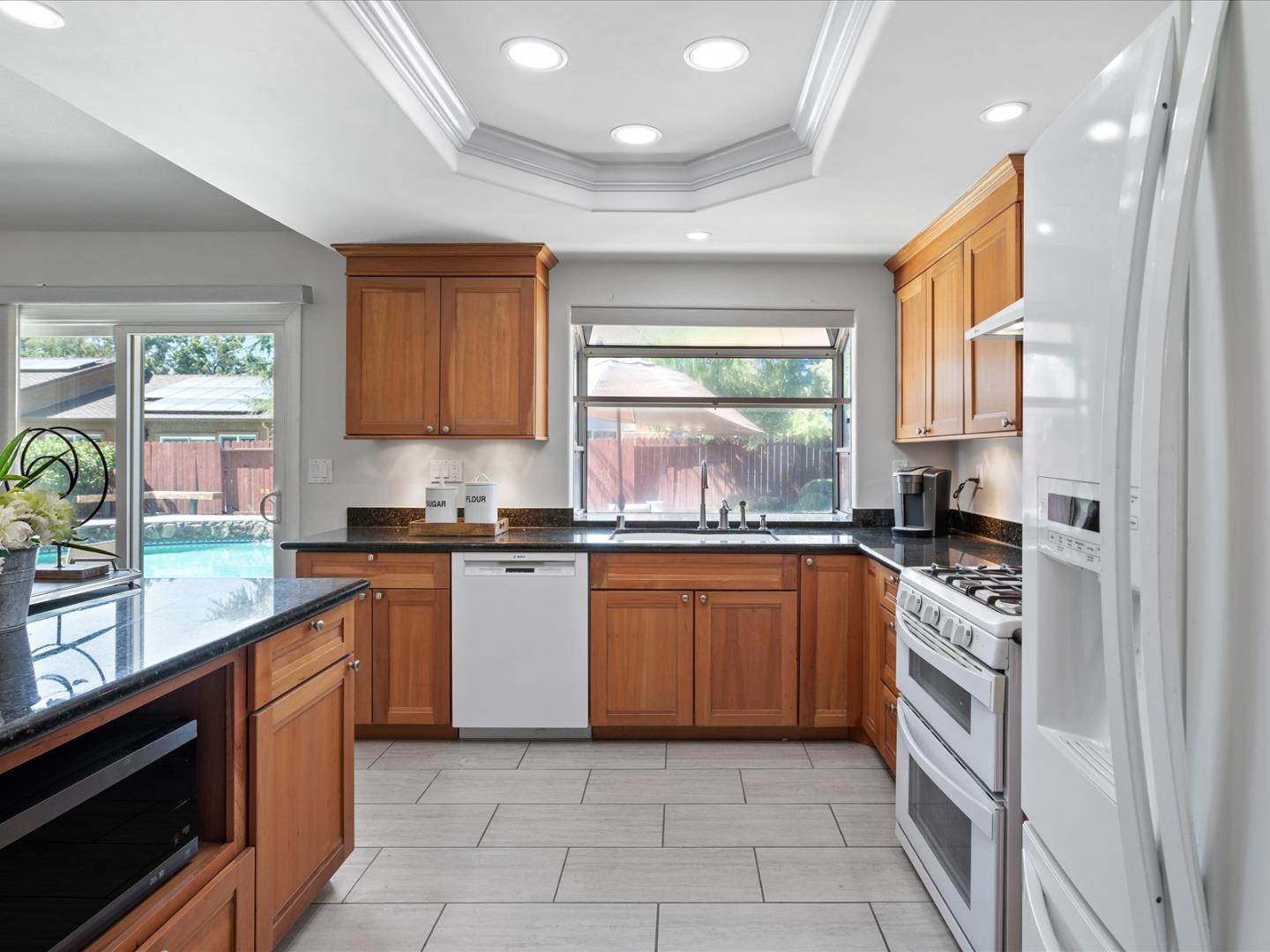 821 Pinehurst Place San Ramon, CA 94583 - Photo 10 of 26 a kitchen with stainless steel appliances granite countertop a stove a sink and a refrigerator