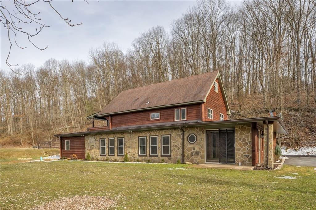 734 Girty Road Shelocta, PA 15774 - Photo 4 of 45 a front view of a house with a garden and trees