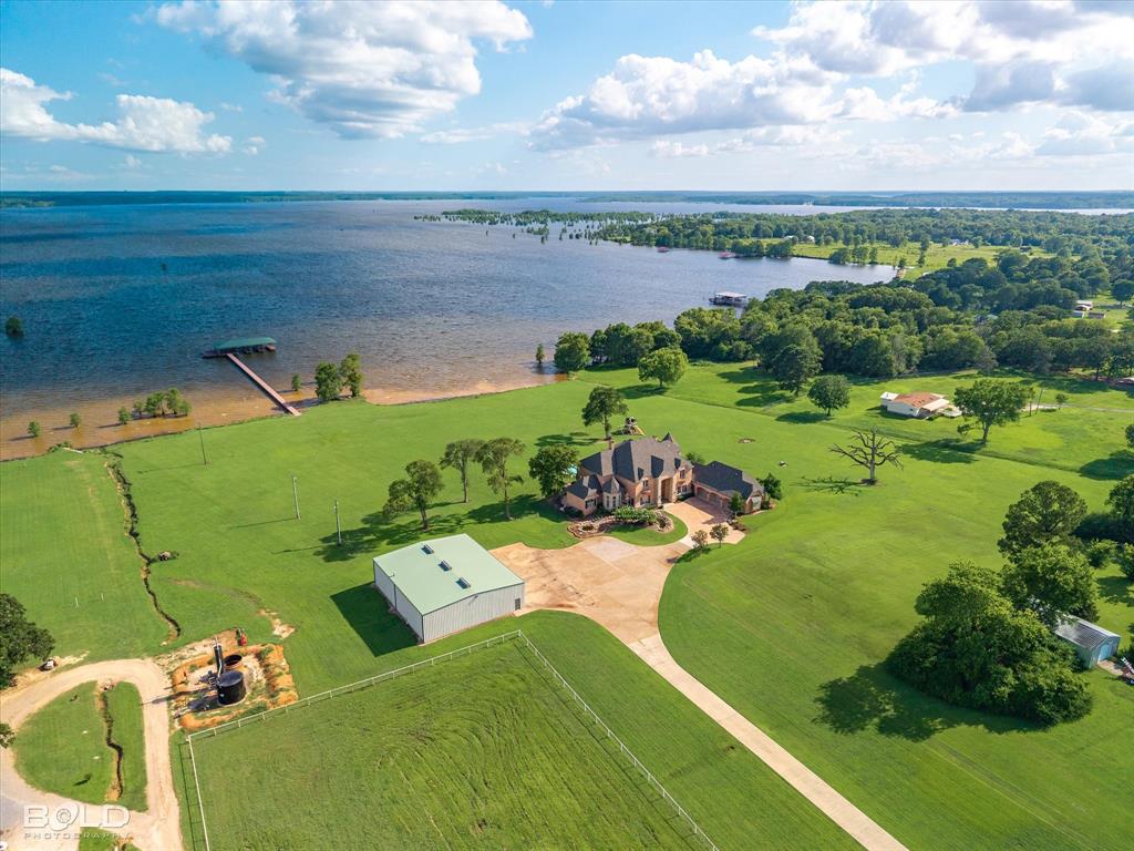 10099 Ferry Lake Road Oil City, LA 71061 - Photo 2 of 14 Breathtaking aerial view showcasing the home, lake, and 7.81 acres