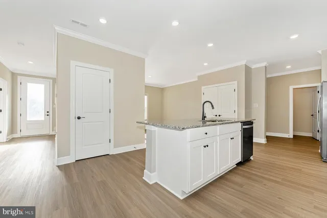 a spacious bathroom with a granite countertop double vanity sink and a mirror