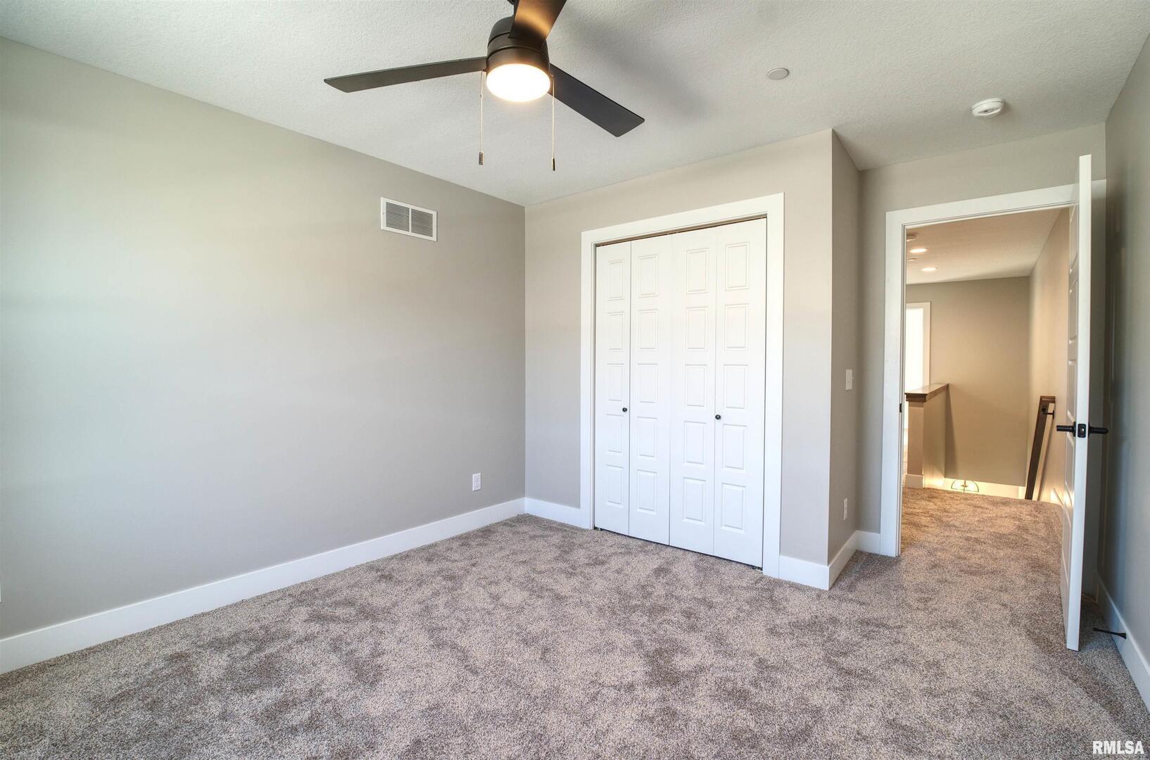 1004 South 4th Street Clinton, IA 52732 - Photo 11 of 18 an empty room with fan and entrance