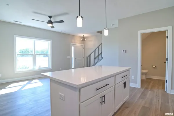 a view of a kitchen counter space a sink and wooden floor