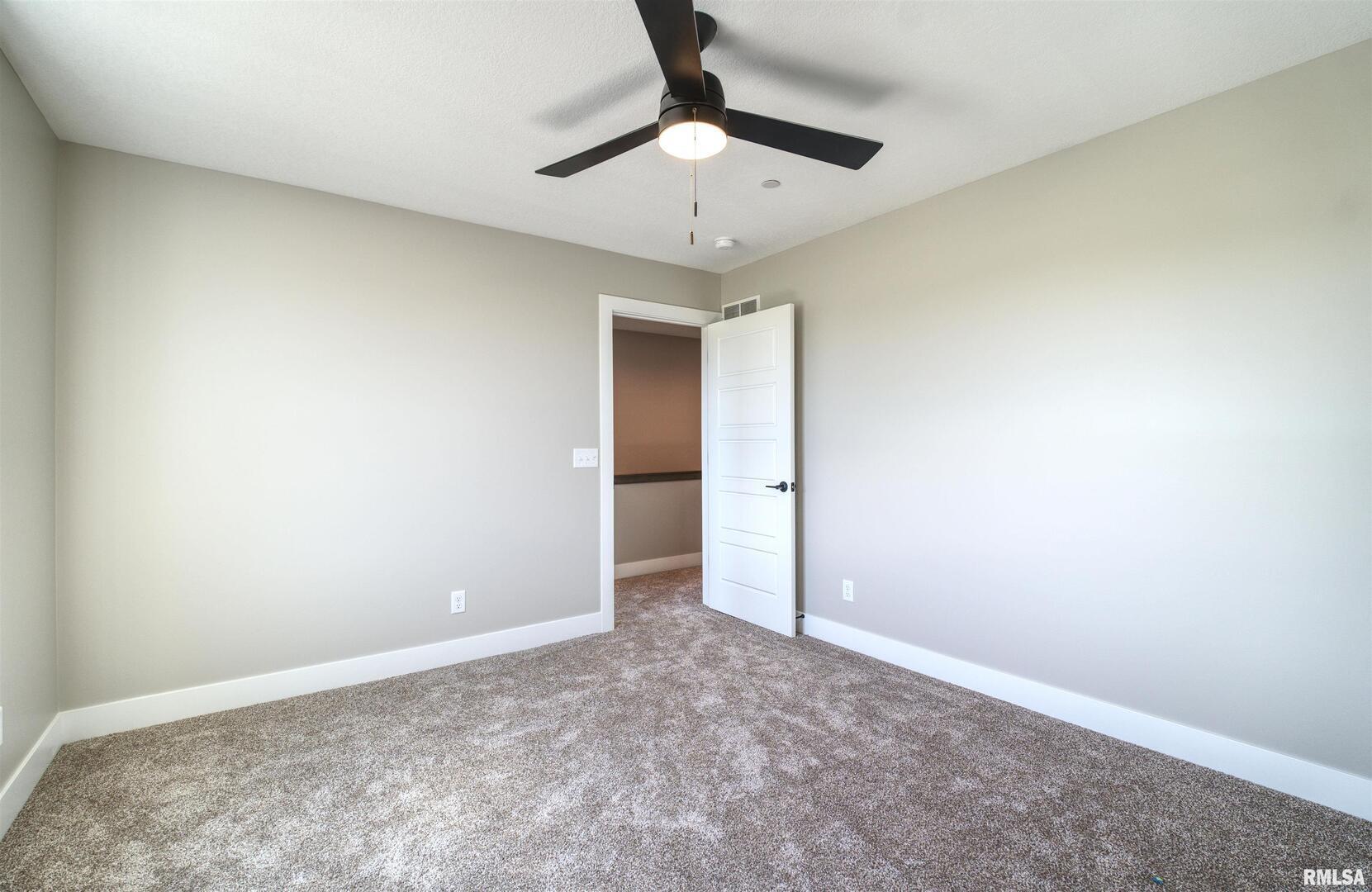 1004 South 4th Street Clinton, IA 52732 - Photo 10 of 18 an empty room with a ceiling fan and carpet