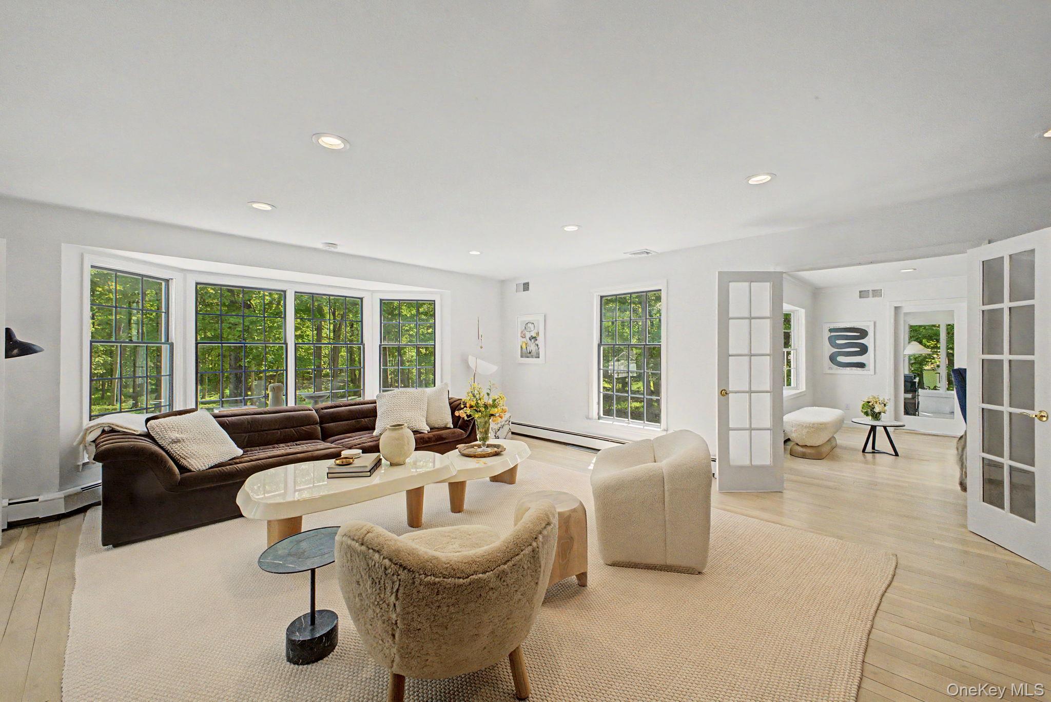 240 Eastwoods Road Pound Ridge, NY 10576 - Photo 21 of 46 a living room with furniture and a large window