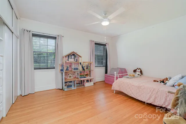 a bedroom with a bed and a chair