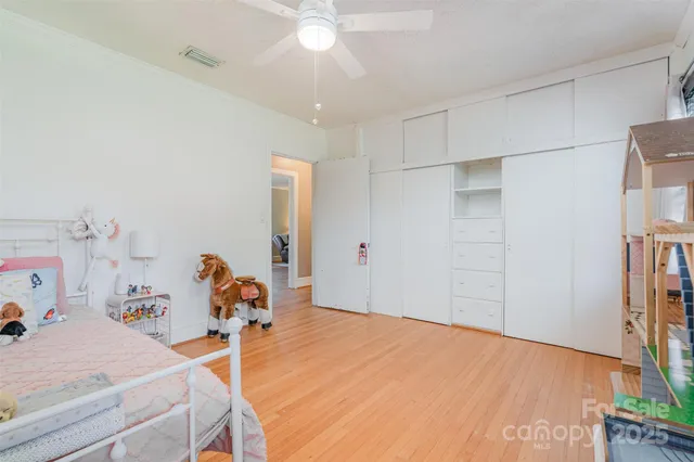 a bed room with a bed and a chandelier
