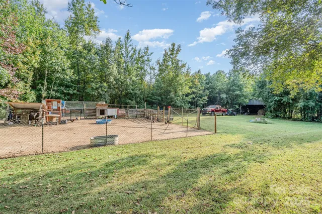 a swimming pool with an outdoor seating and yard