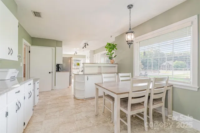 a dining room with furniture and window