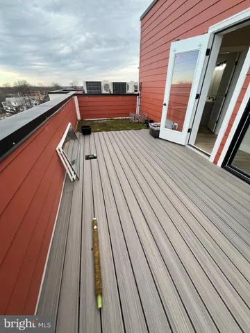 a view of balcony with wooden floor and bench