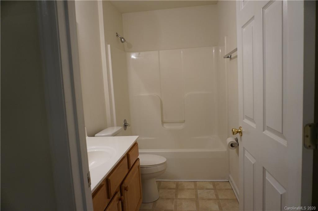 4121 Oakwood Road Charlotte, NC 28269 - Photo 12 of 15 a bathroom with a granite countertop sink a toilet and shower