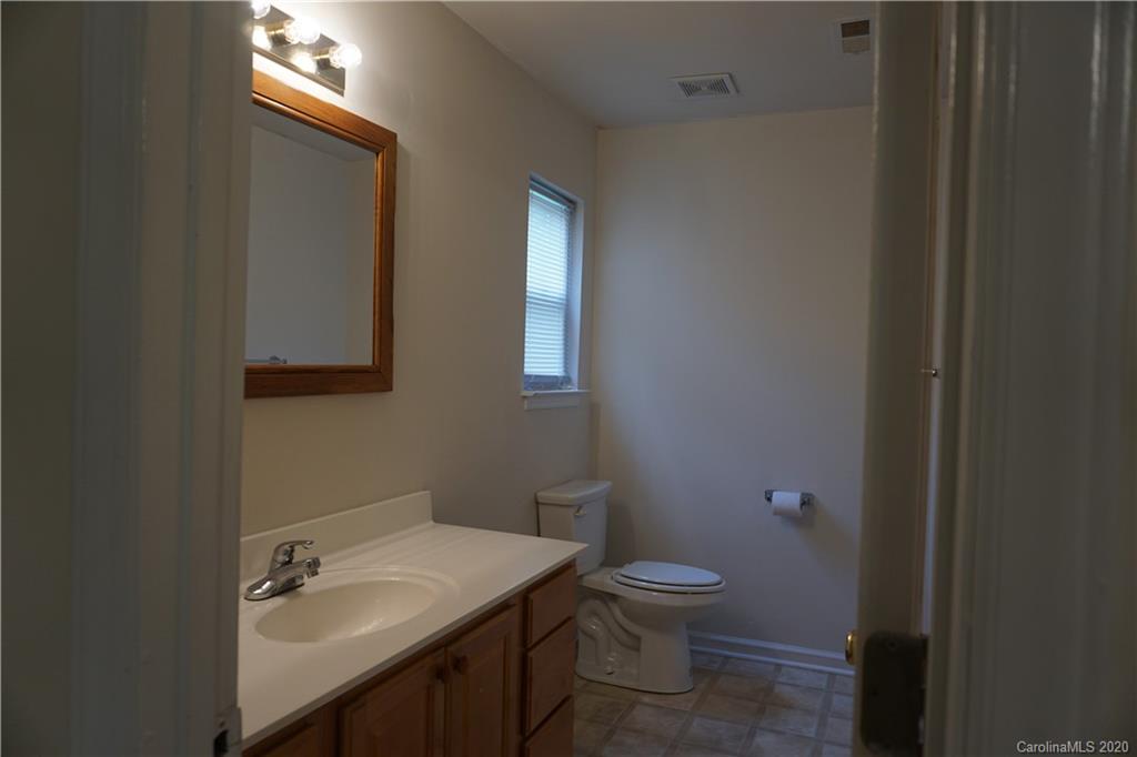 4121 Oakwood Road Charlotte, NC 28269 - Photo 7 of 15 a bathroom with a toilet a sink and mirror