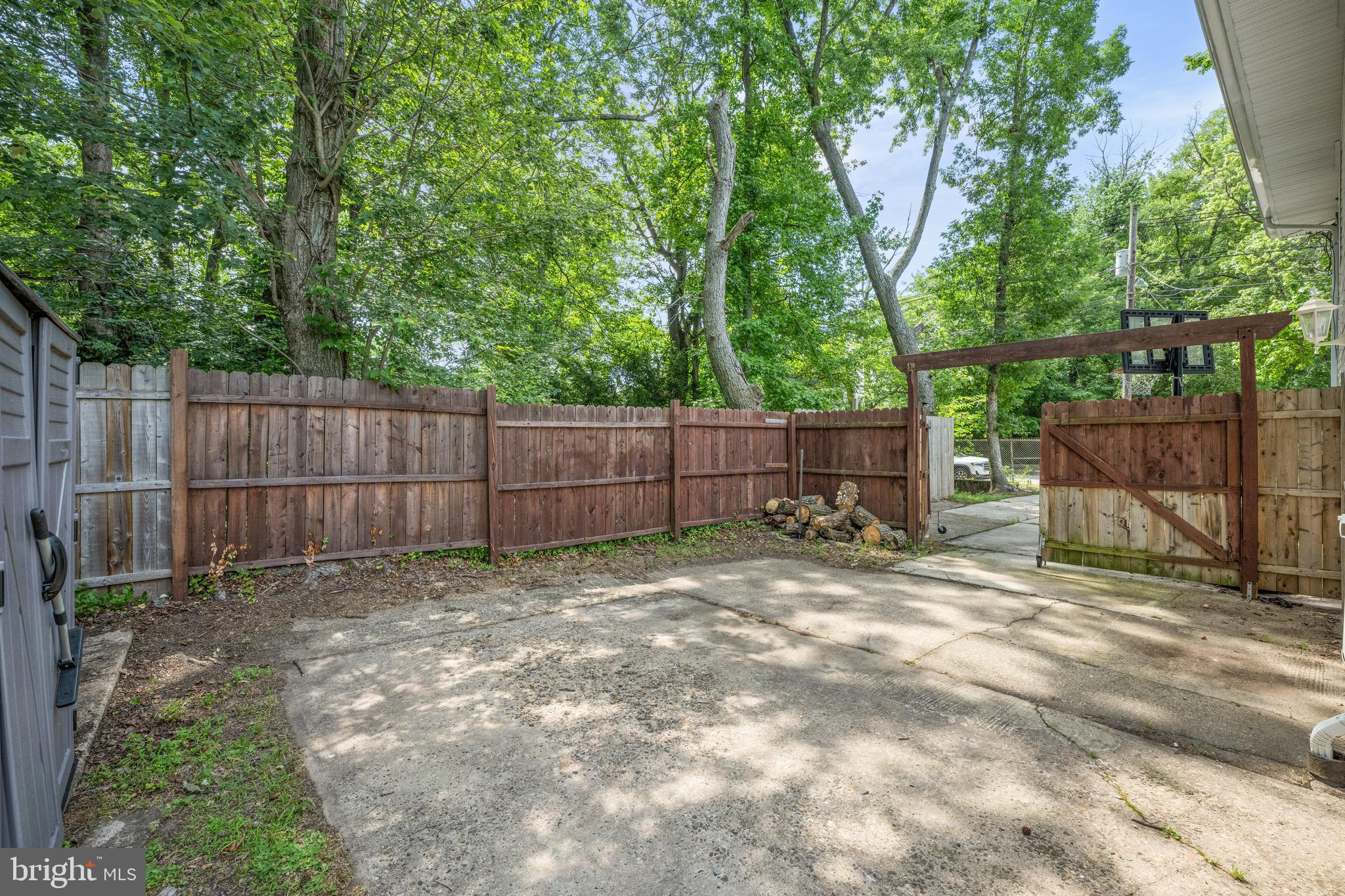 329 Sheffield Road Cherry Hill, NJ 08034 - Photo 27 of 30 a view of a backyard with wooden fence and a large tree