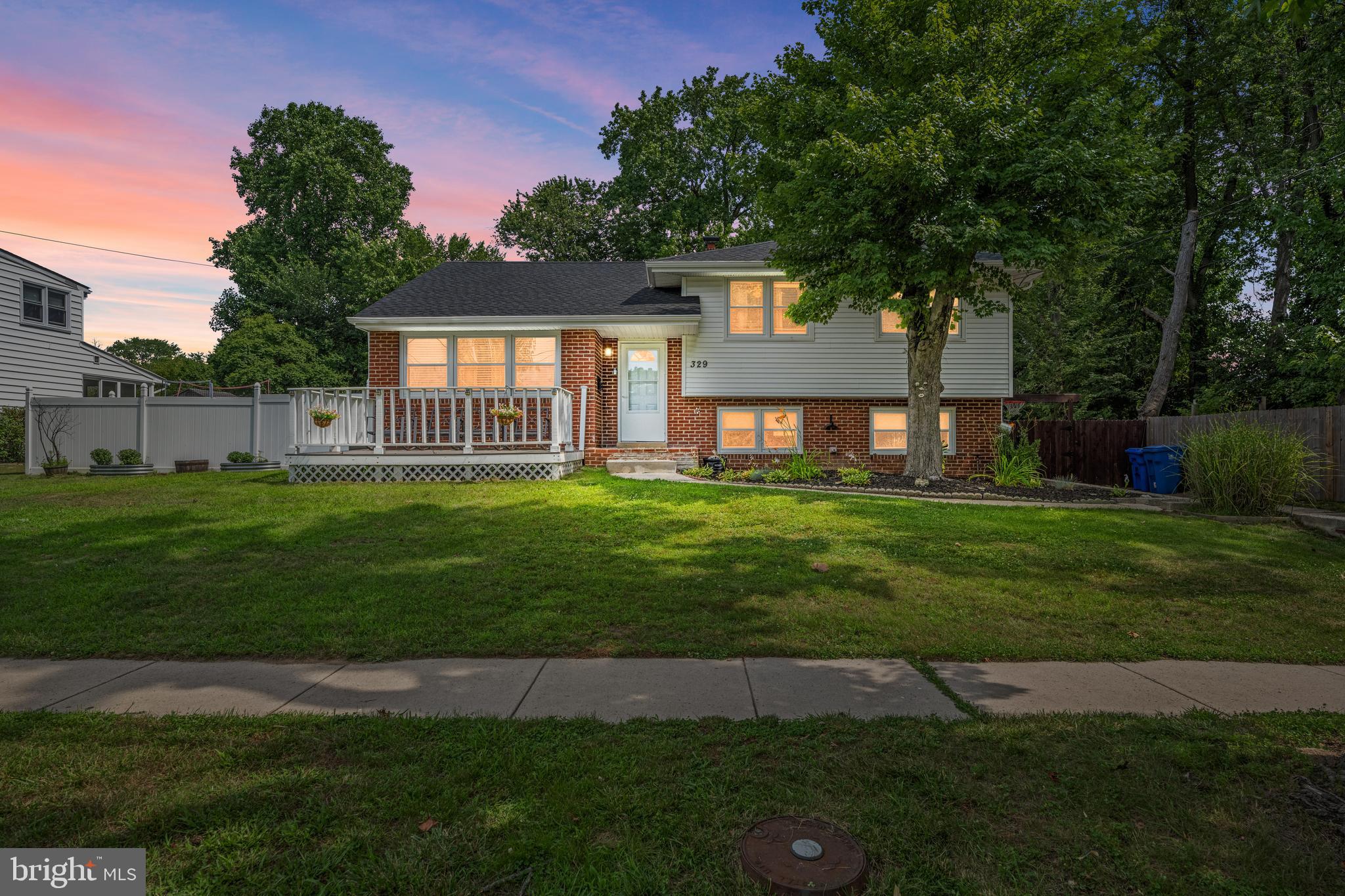 329 Sheffield Road Cherry Hill, NJ 08034 - Photo 29 of 30 a front view of a house with a yard and trees