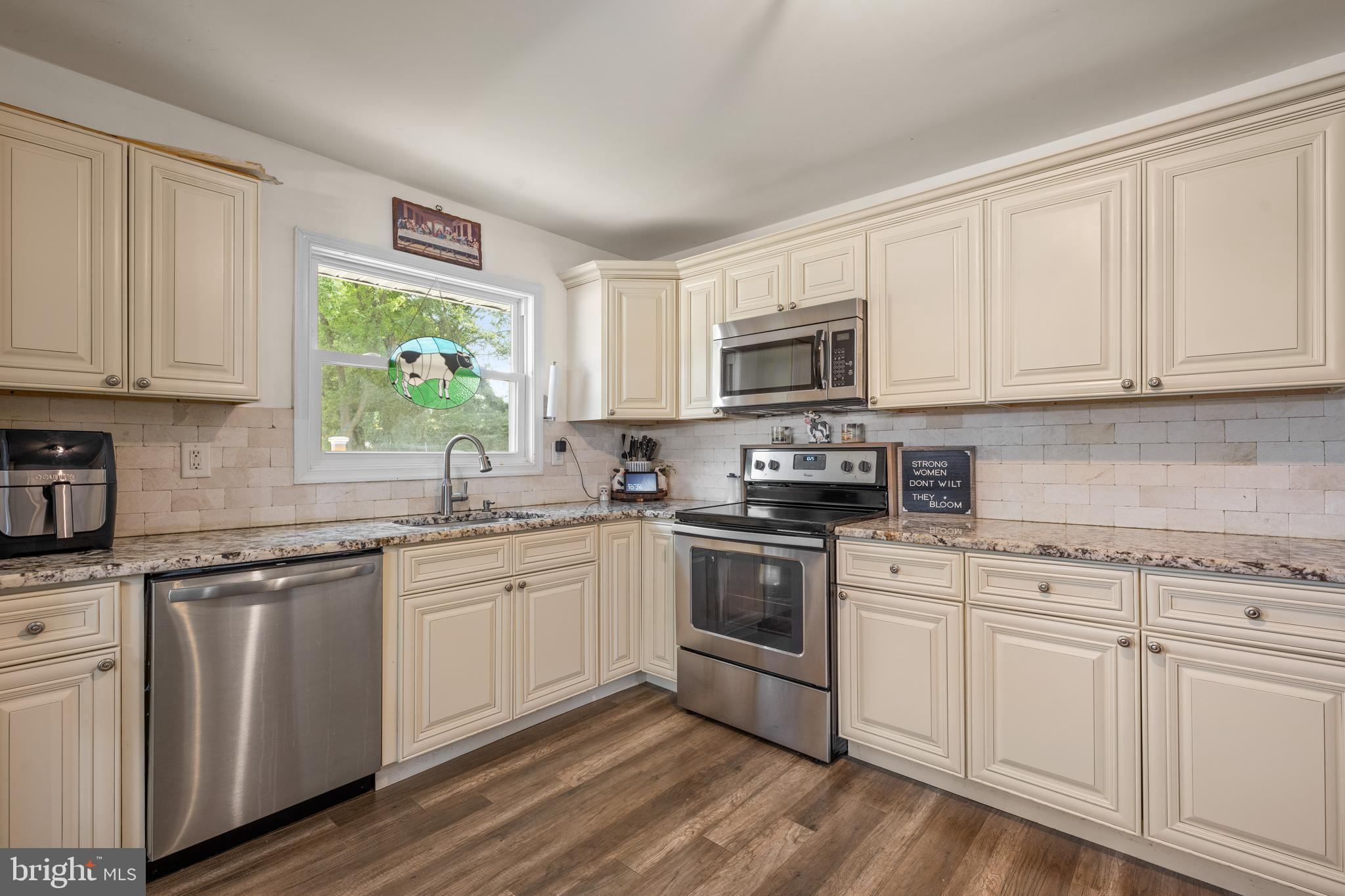 329 Sheffield Road Cherry Hill, NJ 08034 - Photo 5 of 30 a kitchen with granite countertop white cabinets and white appliances