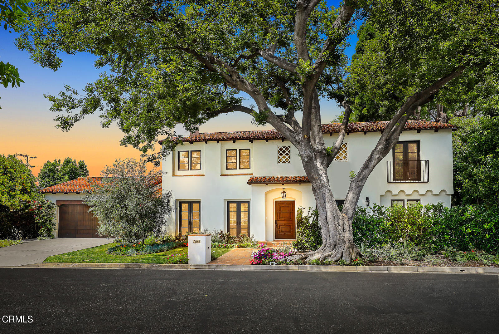 a front view of a house with a garden