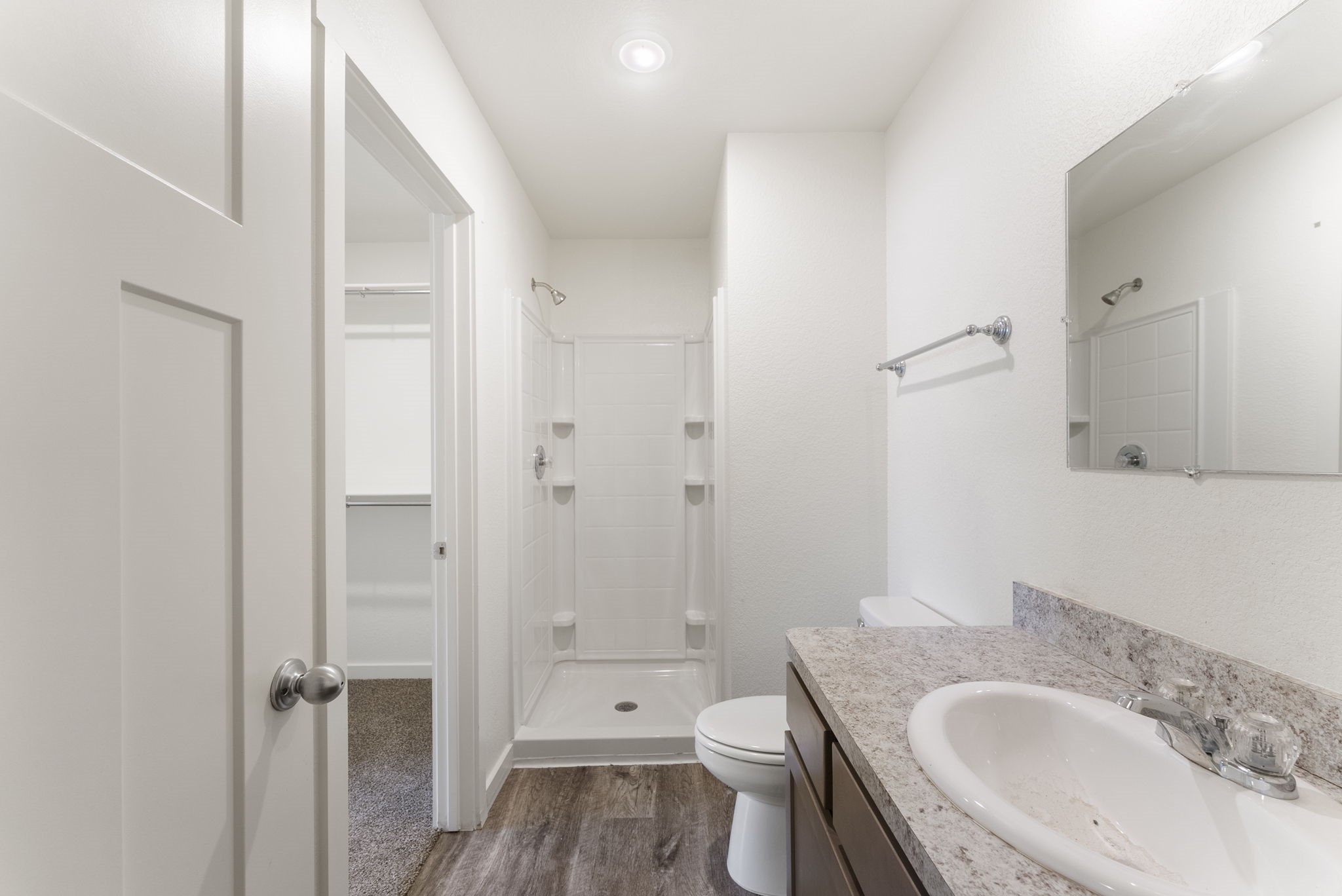 21155 Gosling Road, Unit 22AD Spring, TX 77388 - Photo 16 of 23 a bathroom with a granite countertop toilet a sink and a mirror