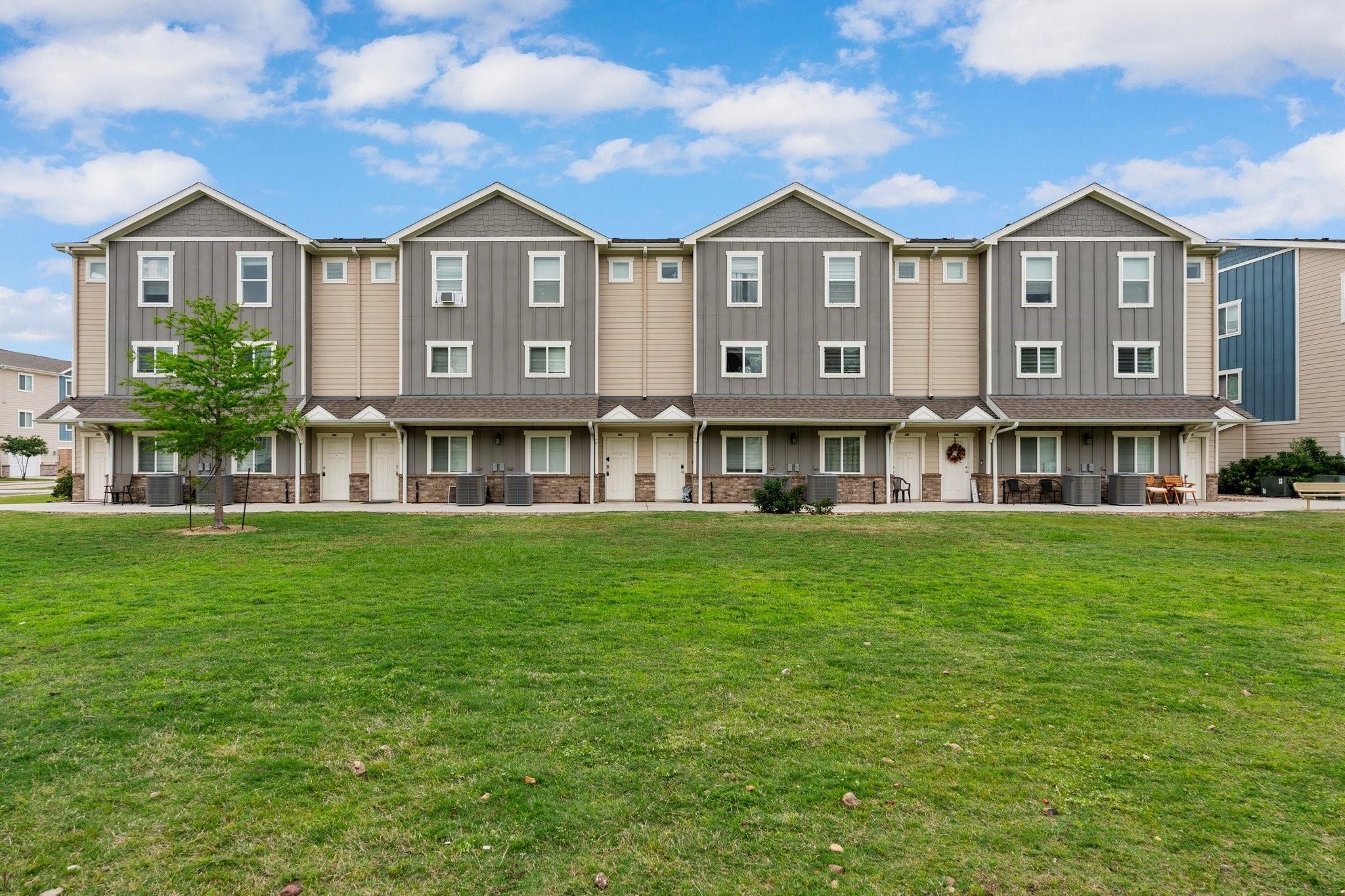 21155 Gosling Road, Unit 22AD Spring, TX 77388 - Photo 20 of 23 a view of a big house with a big yard and large trees