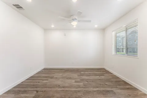 wooden floor in an empty room with a window