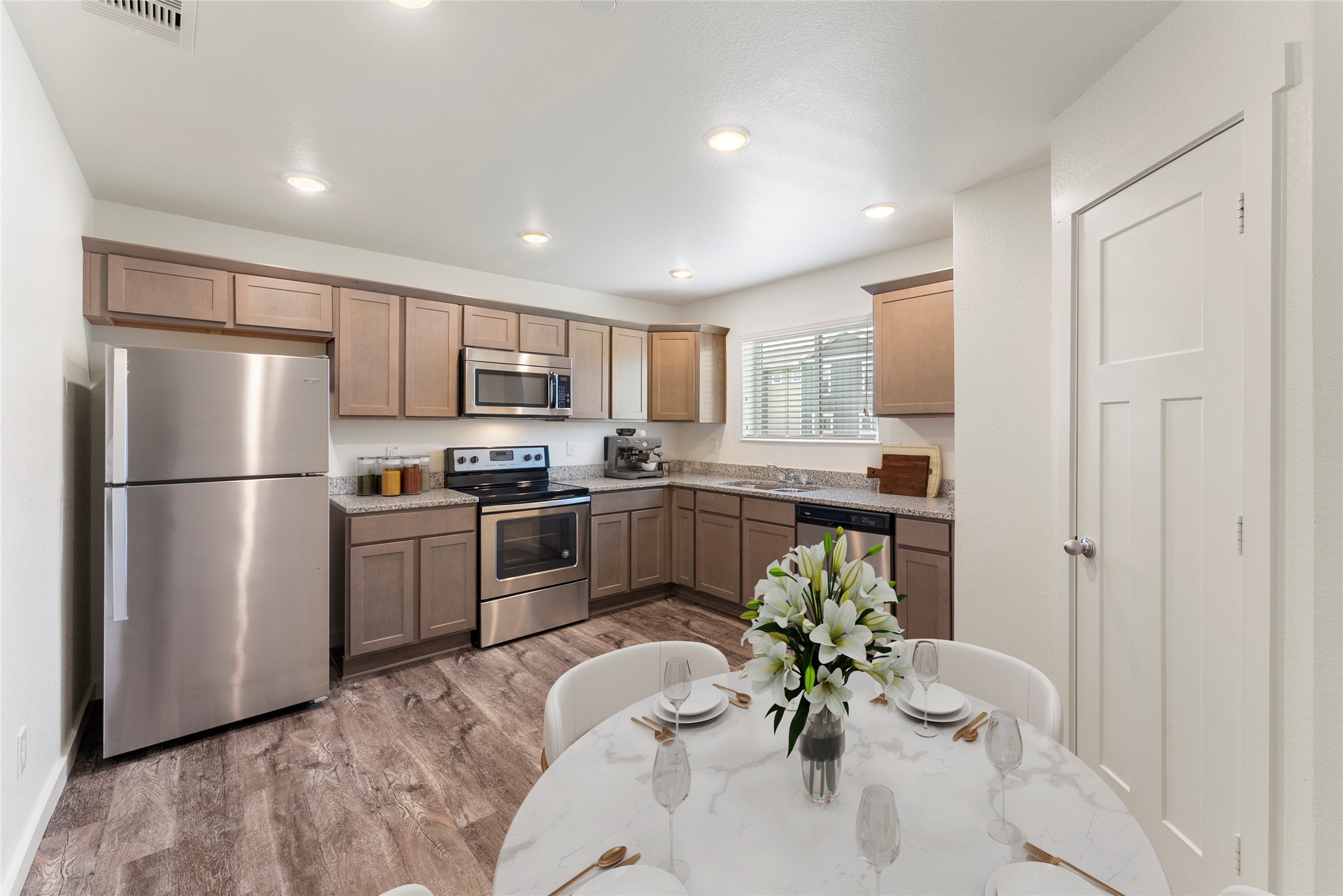 21155 Gosling Road, Unit 22AD Spring, TX 77388 - Photo 7 of 23 a kitchen with a refrigerator and a dining table