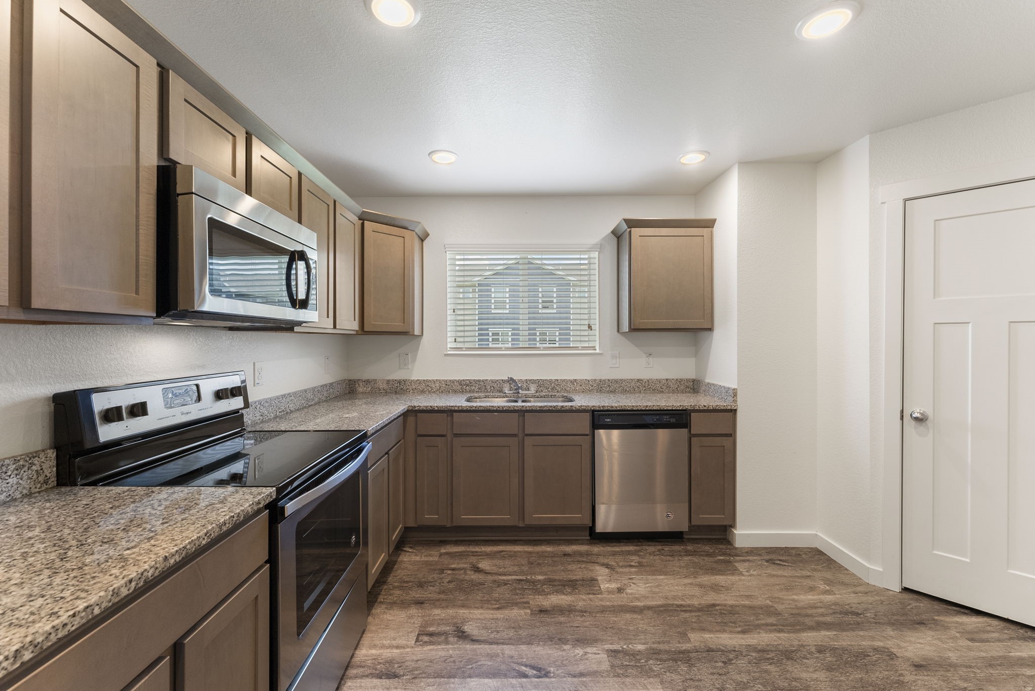 21155 Gosling Road, Unit 22AD Spring, TX 77388 - Photo 9 of 23 a kitchen with stainless steel appliances granite countertop a stove a sink and a microwave