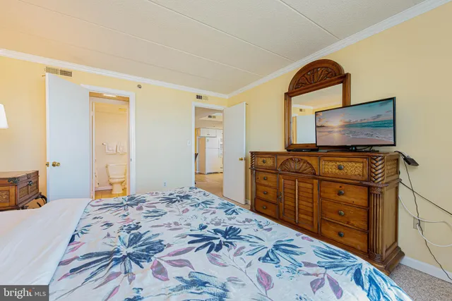 a bedroom with a bed and a flat screen television