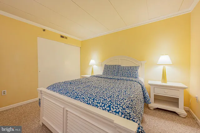 a bedroom with a bed and a lamp