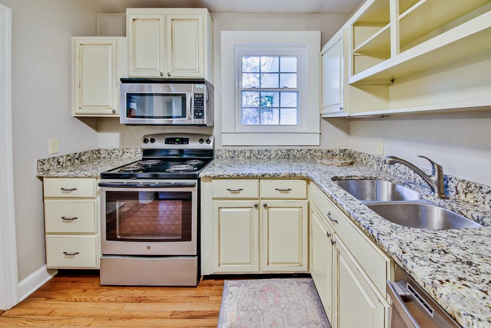 4964 Sequoia Road Memphis, TN 38117 - Photo 8 of 18 a kitchen with stainless steel appliances granite countertop a sink stove and cabinets