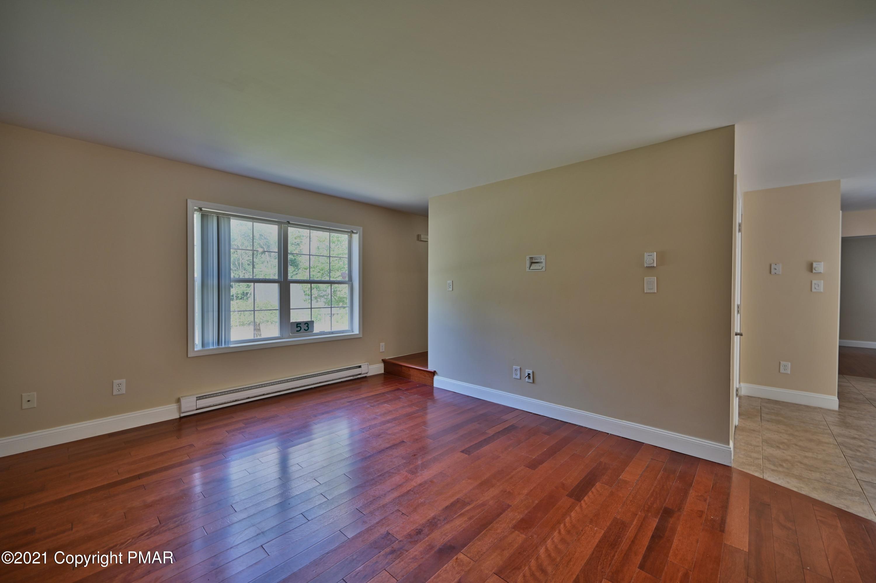 53 Seneca Road Mount Pocono, PA 18344 - Photo 20 of 41 an empty room with wooden floor and windows