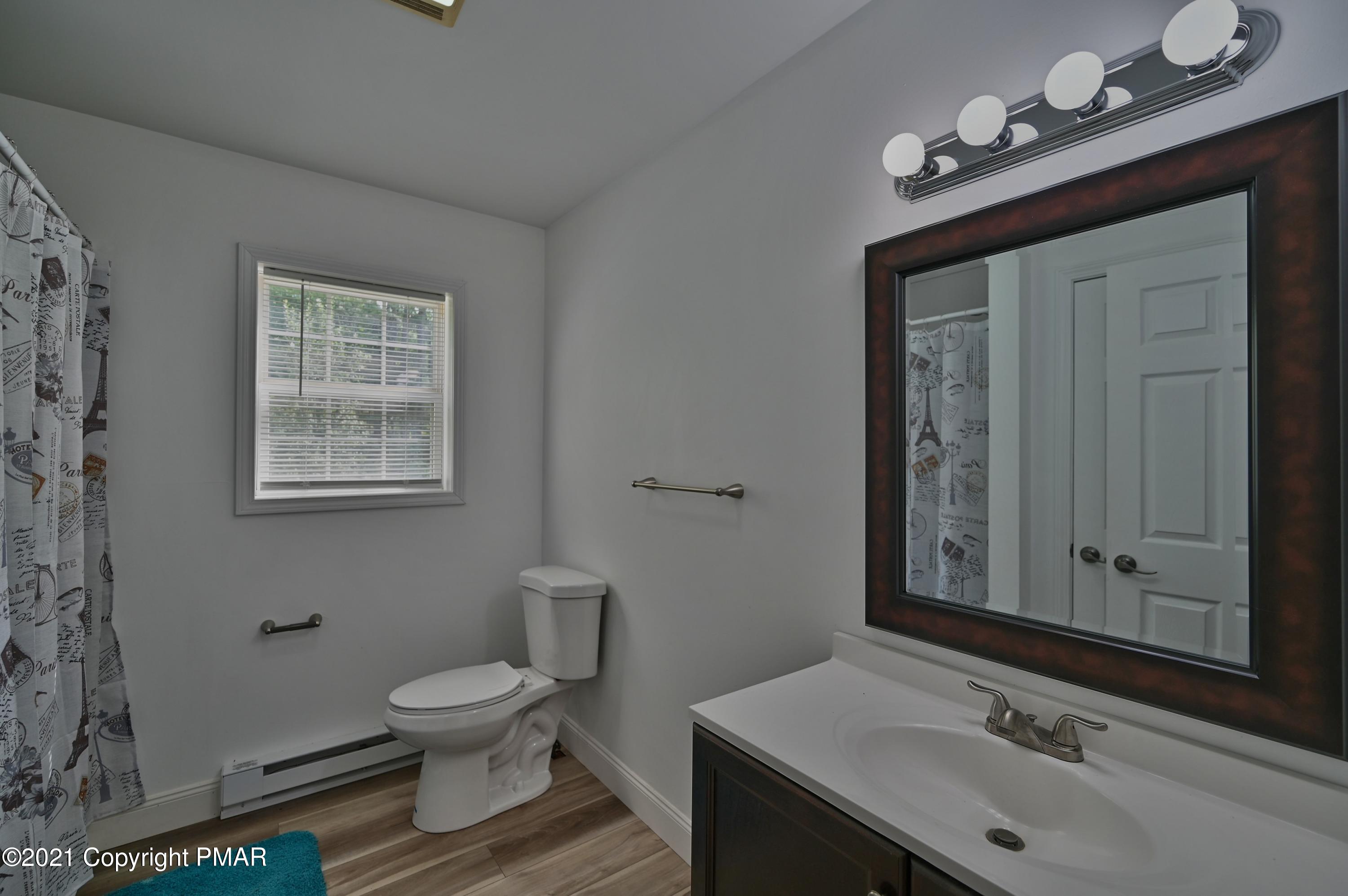 53 Seneca Road Mount Pocono, PA 18344 - Photo 33 of 41 a bathroom with a sink a toilet and mirror