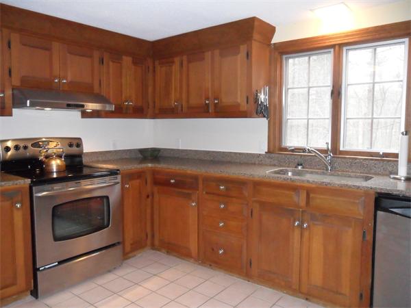 350 Berlin Road Bolton, MA 01740 - Photo 8 of 30 a kitchen with stainless steel appliances granite countertop a stove a sink and a microwave