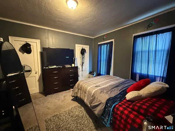 a bedroom with a bed and a closet