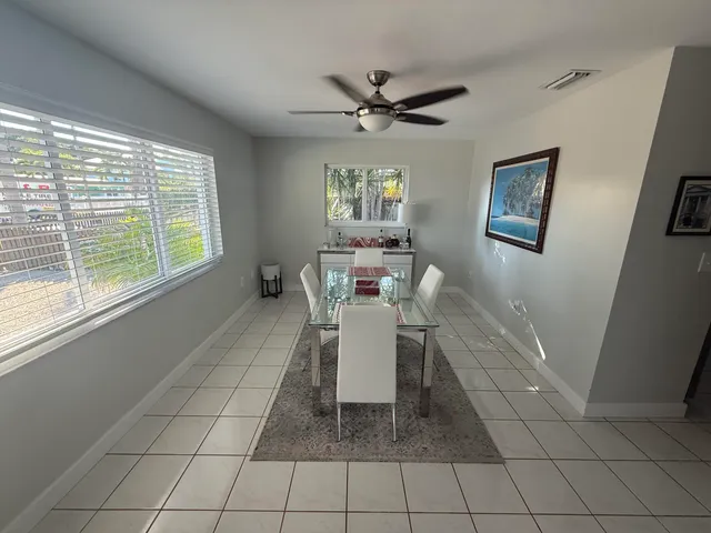 a dining room with chandelier and window