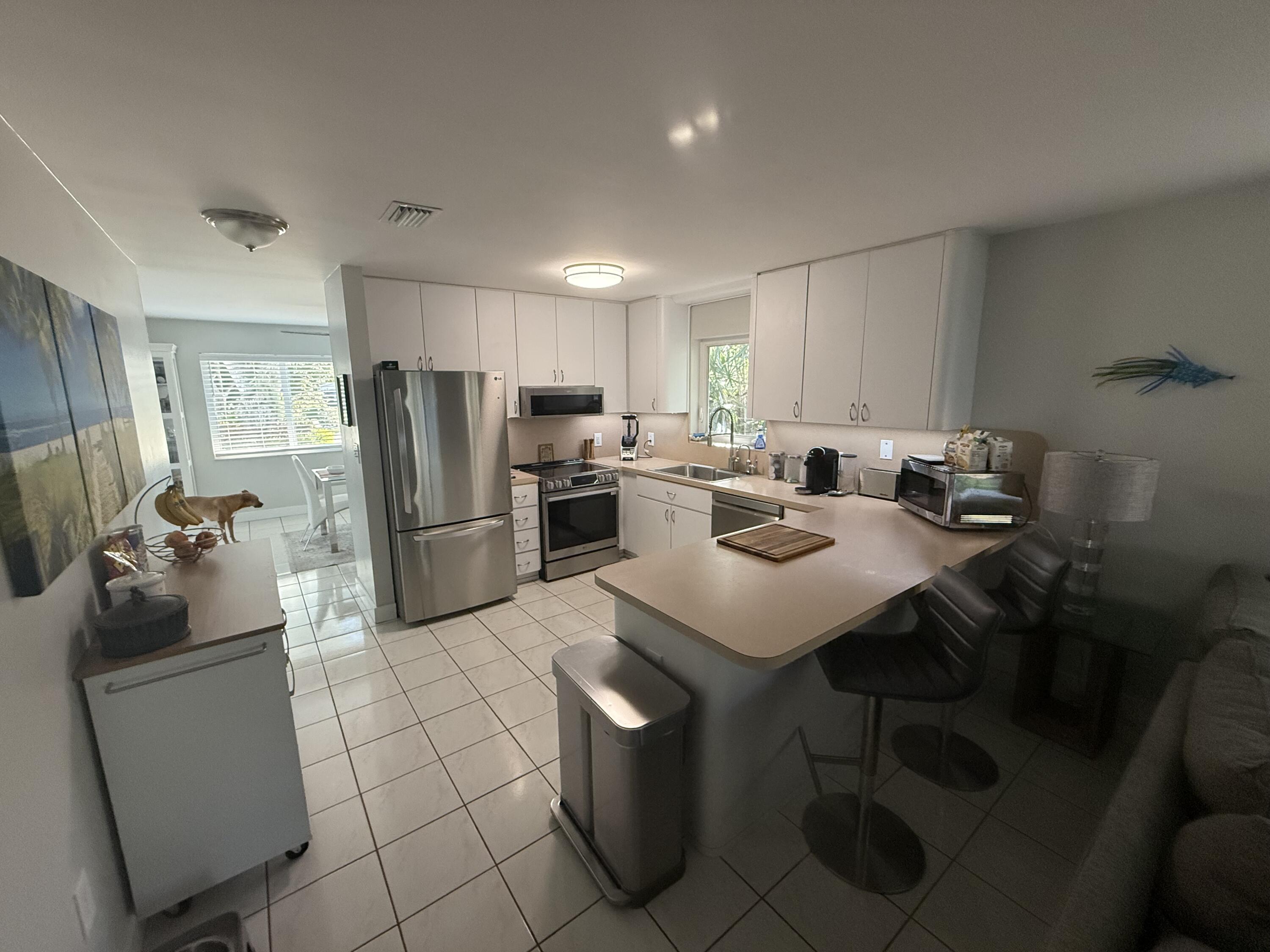 8 North End Road Key Largo, FL 33037 - Photo 5 of 16 a kitchen with a refrigerator and a stove