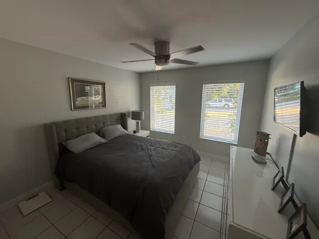 a bedroom with a bed and a flat screen tv