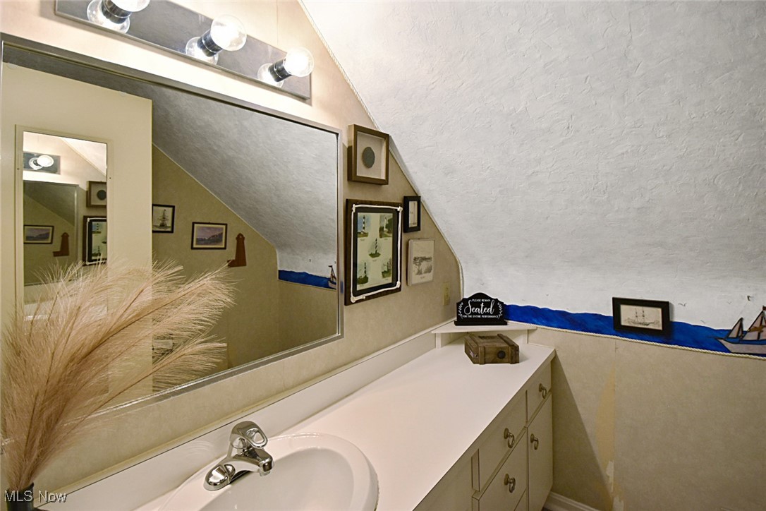 1388 Ford Road Lyndhurst, OH 44124 - Photo 30 of 39 Bathroom featuring vanity, a textured ceiling, and vaulted ceiling