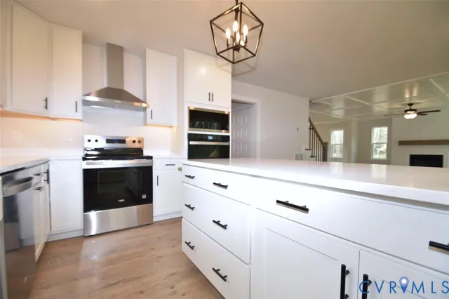 a kitchen with granite countertop a stove and a sink